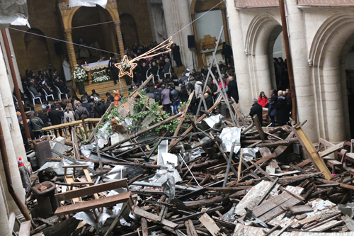 This Syrian church met for a Christmas service despite the back of the church being destroyed small