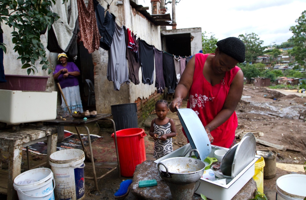 Woman washing dishes in South Africa
