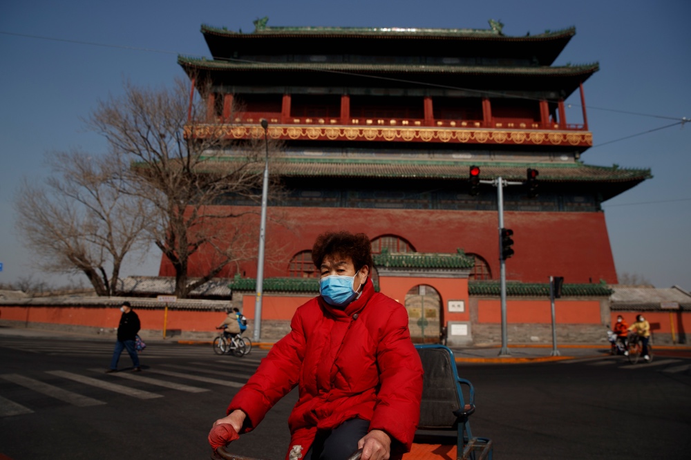 Coronavirus Beijing masked cyclist