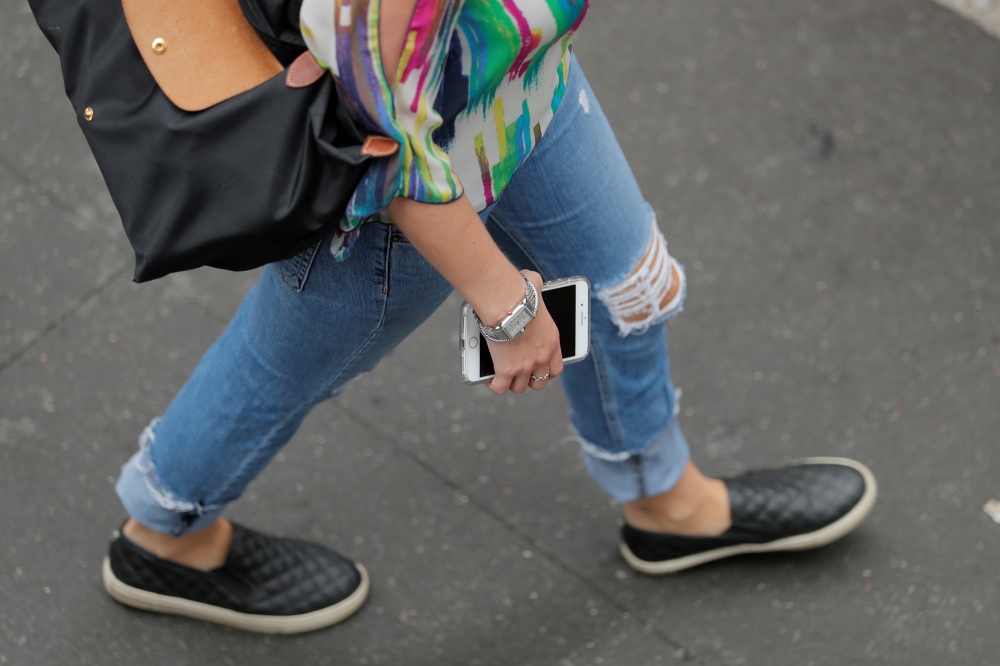 Woman walking with phone