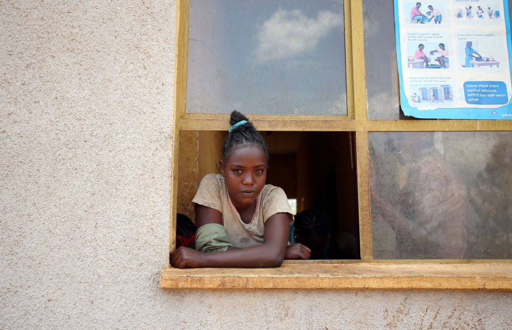 Ethiopia IDP camp girl at window
