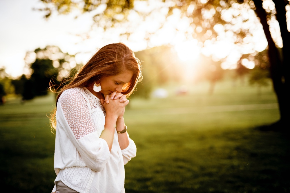 Woman praying outside