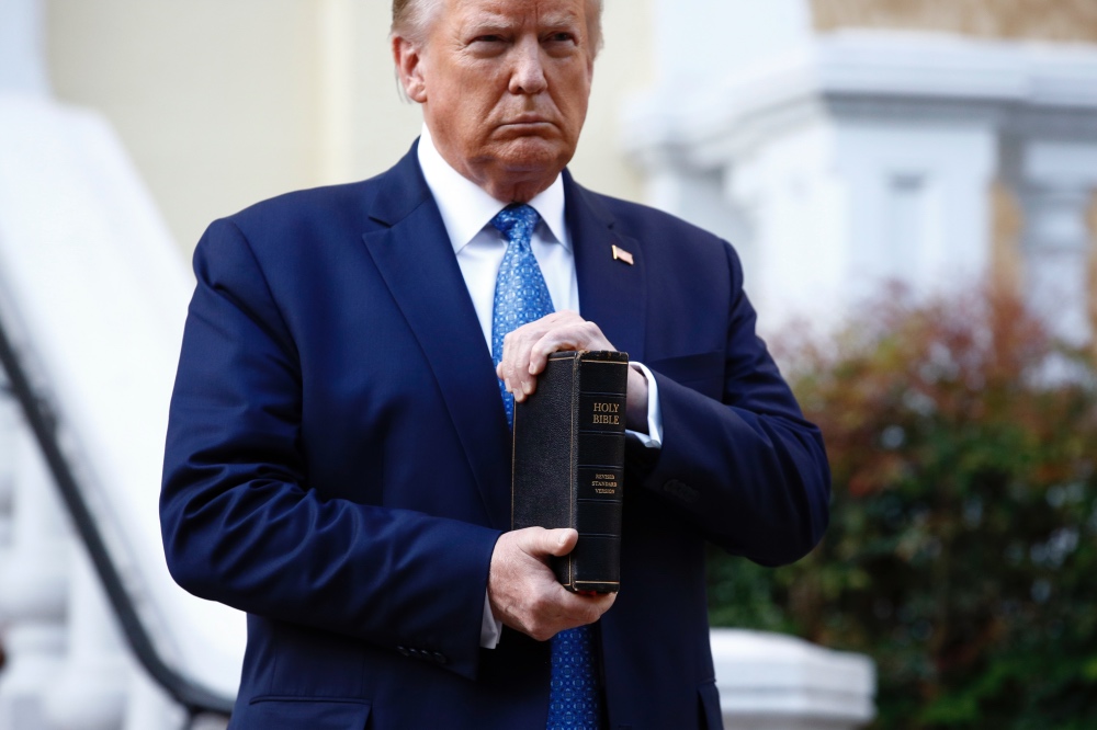 US President Donald Trump holds Bible outside St Johns