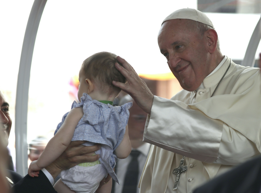 Pope Francis blessing a child