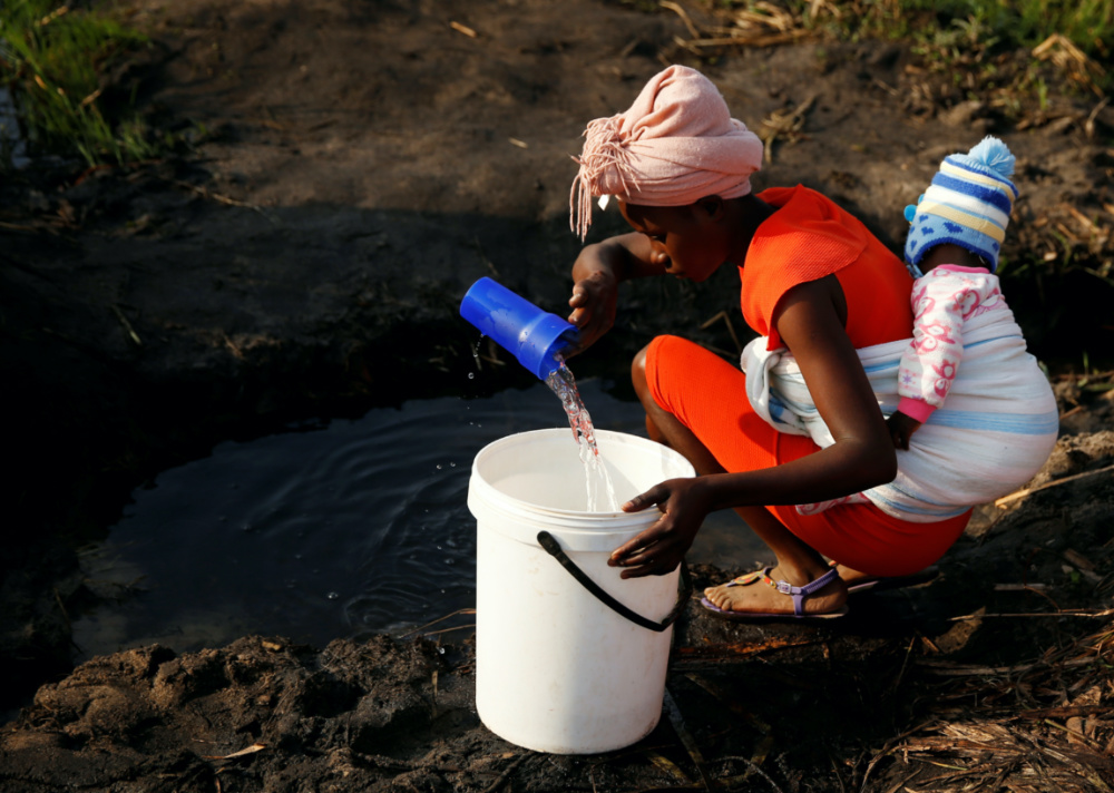 Zimbabwe a woman collects water
