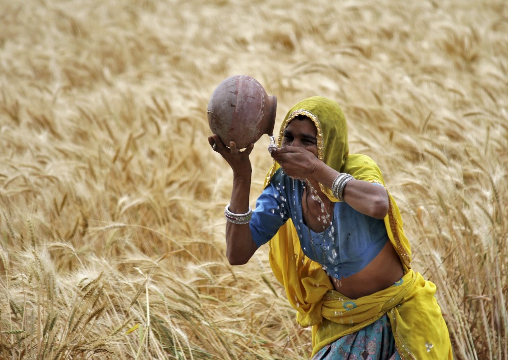 India female farmer drinking