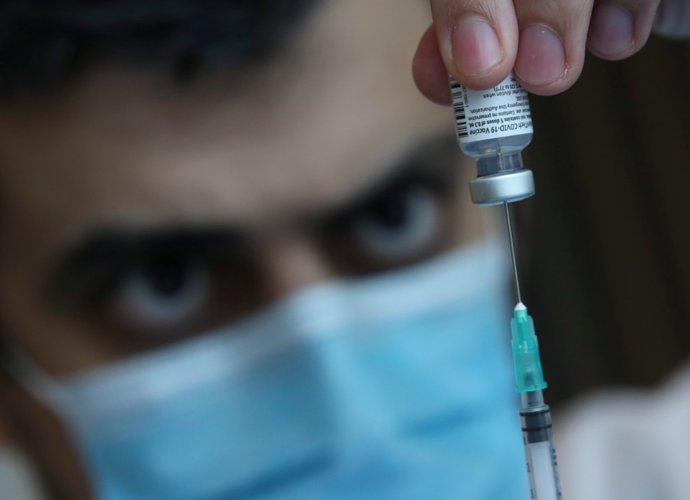 Coronavirus Belgium vaccine and syringe