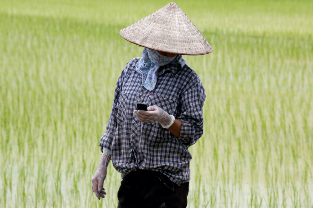 Vietnam rice farmer on phone