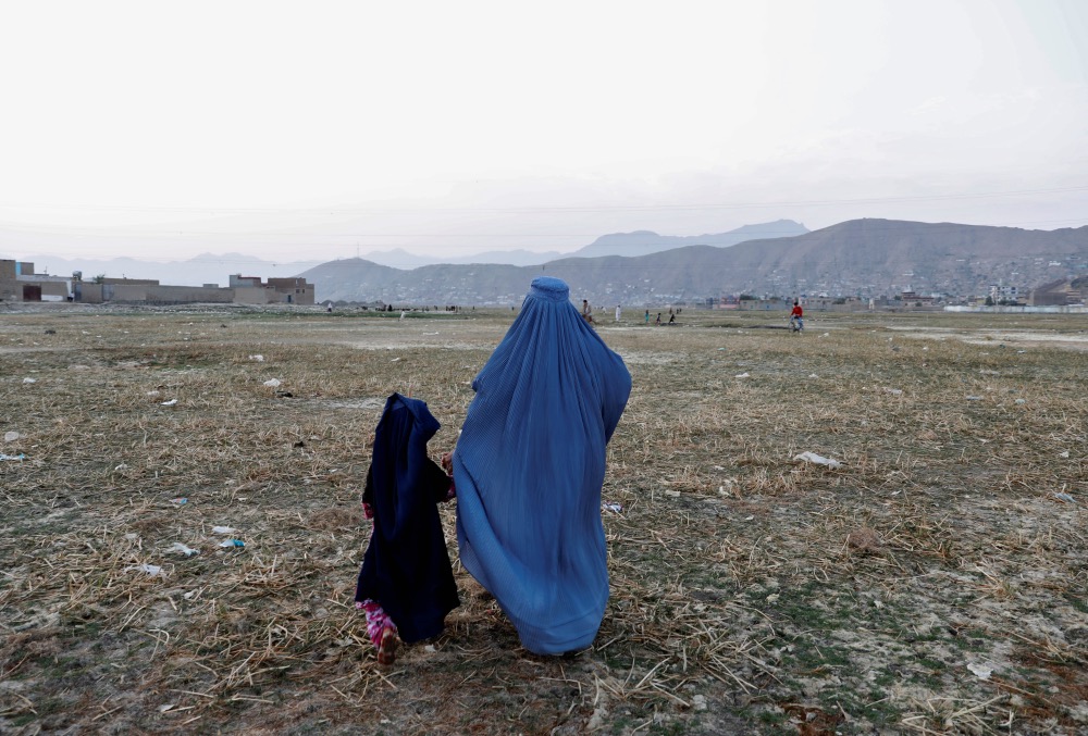 Afghanistan woman and child walking