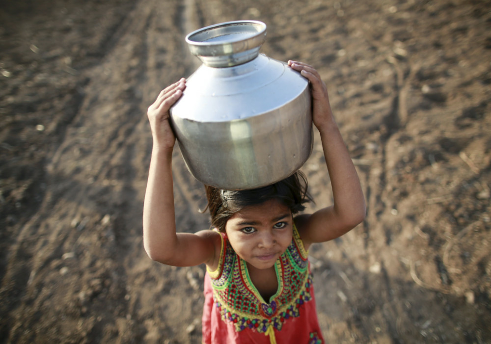 India girl carrying water