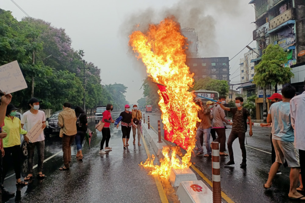 Myanmar Yangon protestors burn a Chinese flag