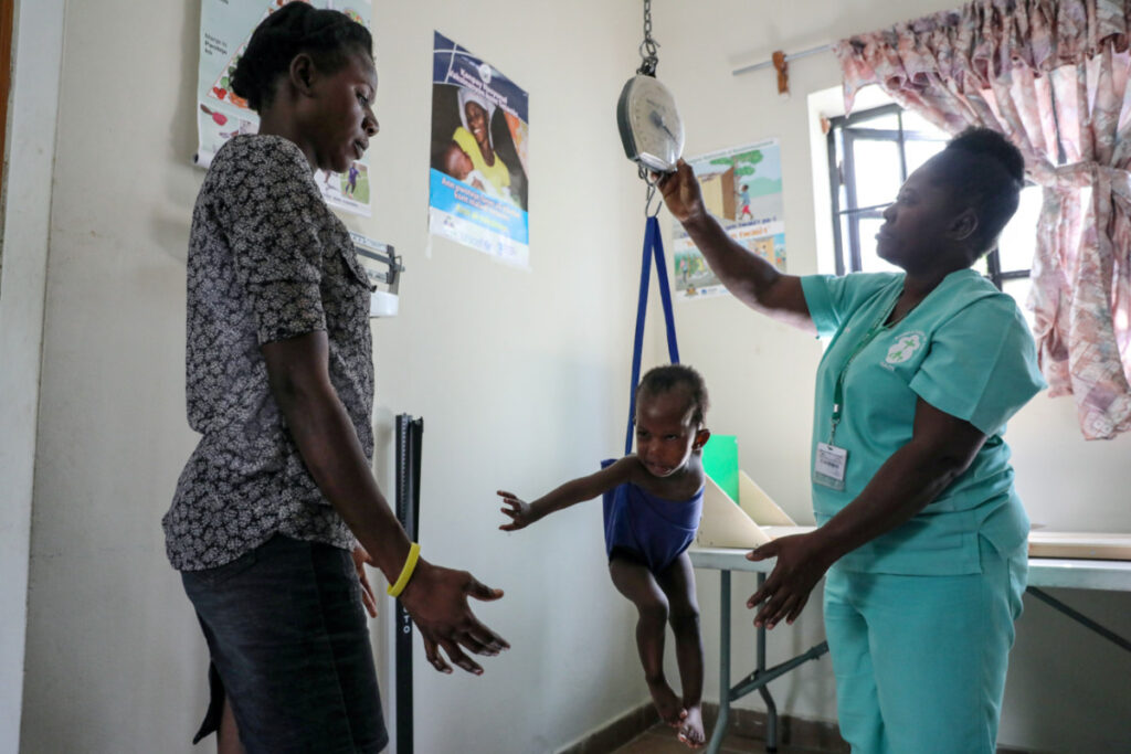 Haiti Port au Prince weighing a child