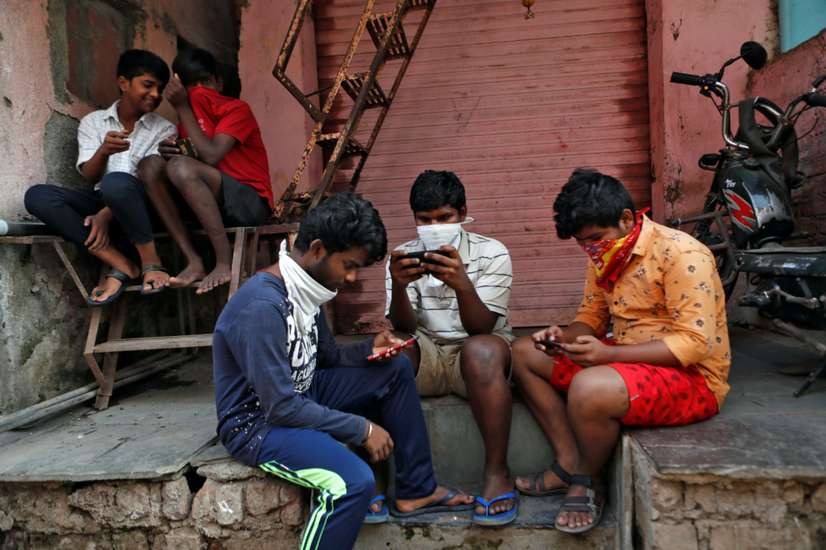 India Mumbai boys looking at phones