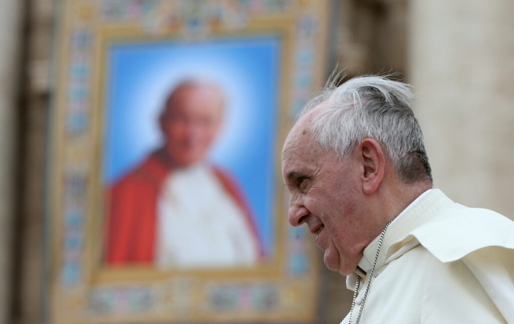 Vatican Pope Francis passes picture of Pope John Paul II