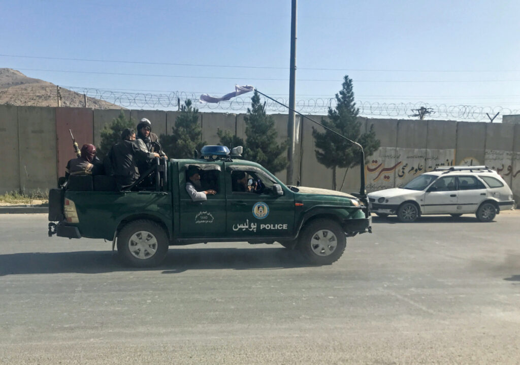 Afghanistan Kabuk Taliban on police vehicle