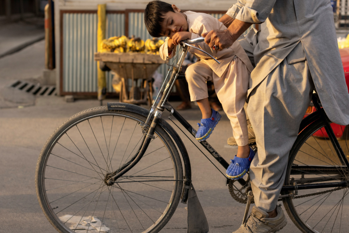 Afghanistan Kabul boy sleeping on bike