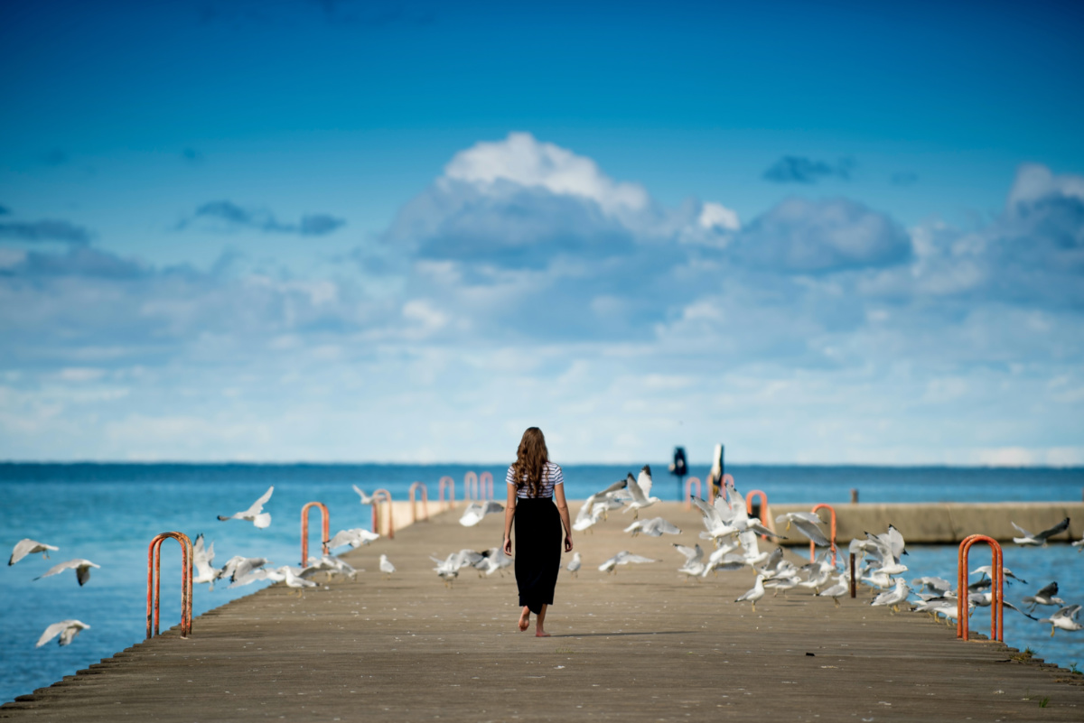 Woman walking on pier