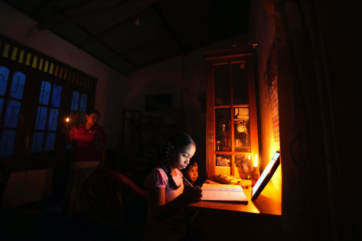 Sri Lanka Colombo girl learning by lamplight