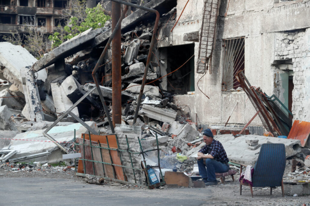Ukraine Mariupol resident near destroyed building