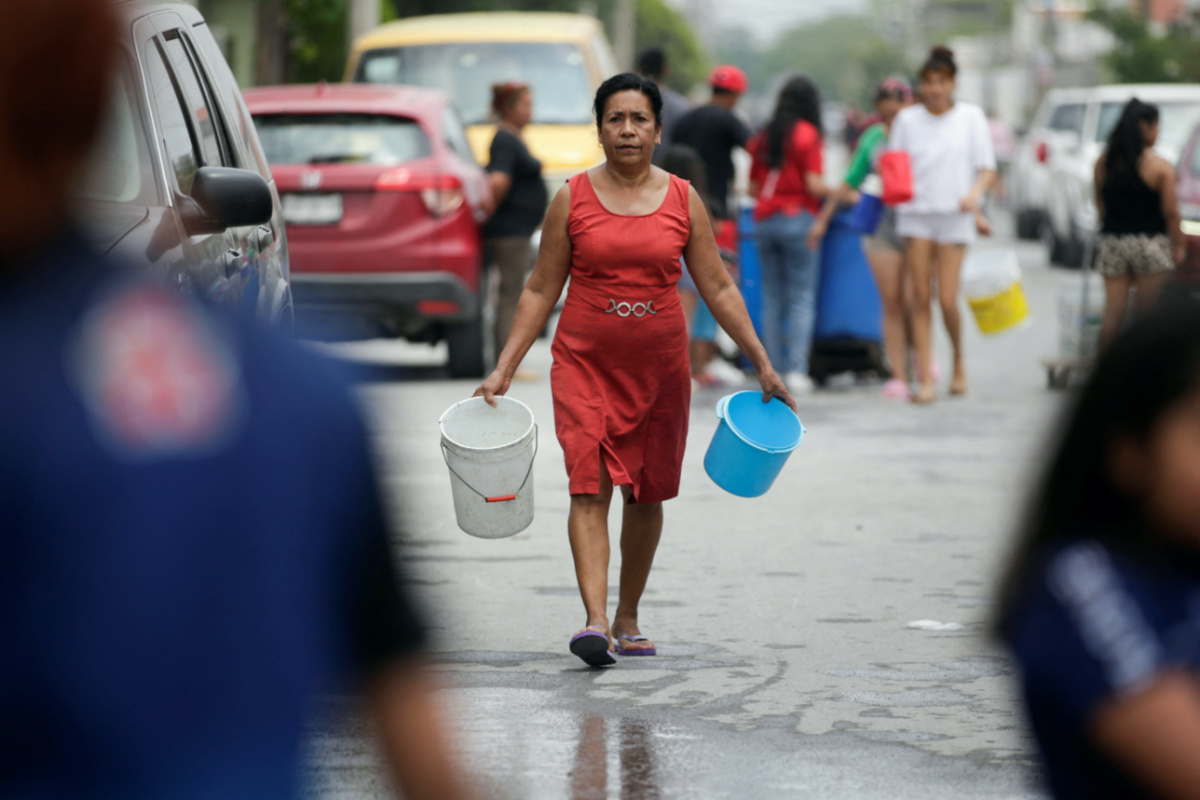 Mexico Escobedo woman with buckets