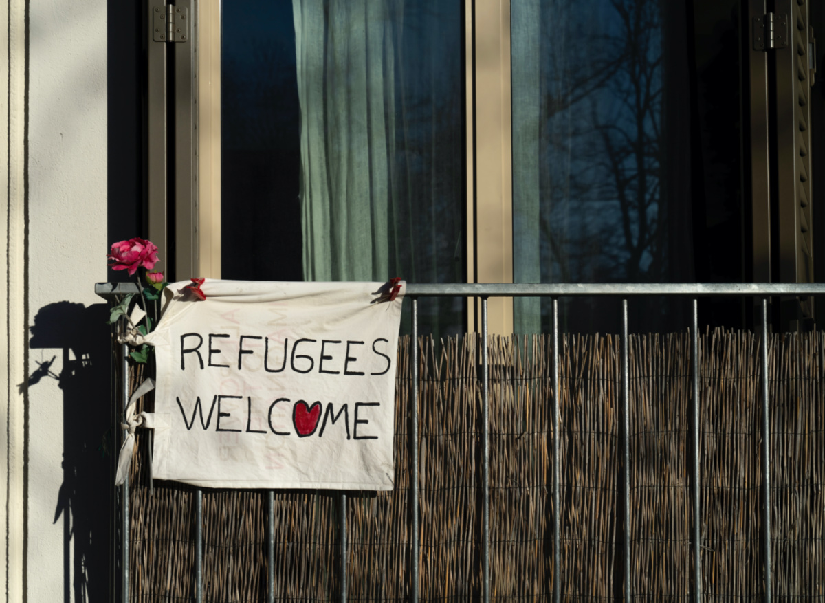 Switzerland refugees welcome sign