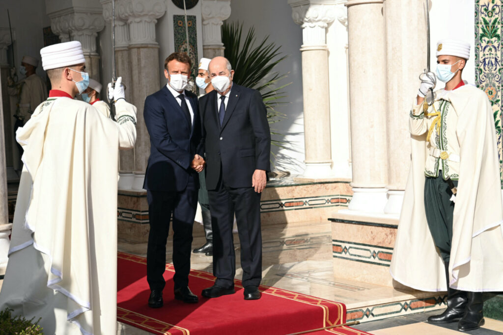 Algeria French President Emmanuel Macron shakes hand with Algerian President Abdelmadjid Tebboune
