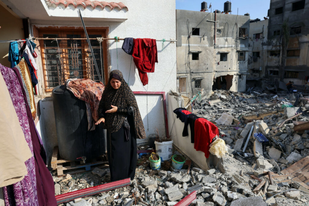 Gaza City woman hanging laundry