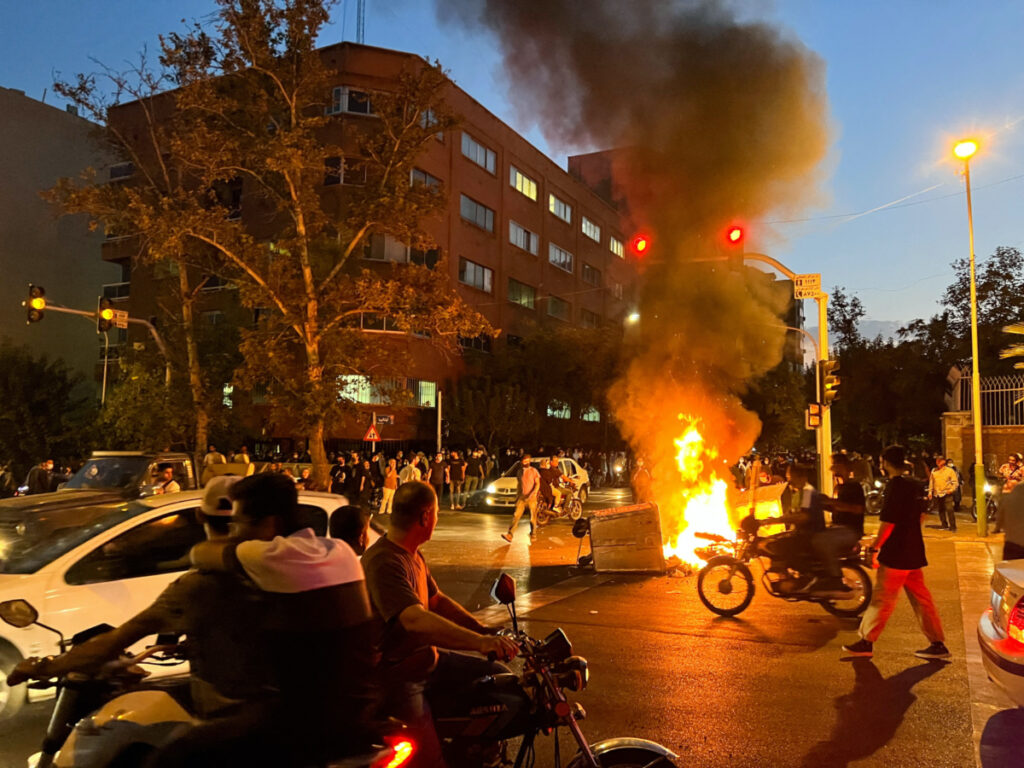 Iran Tehran protests burning motorcycle