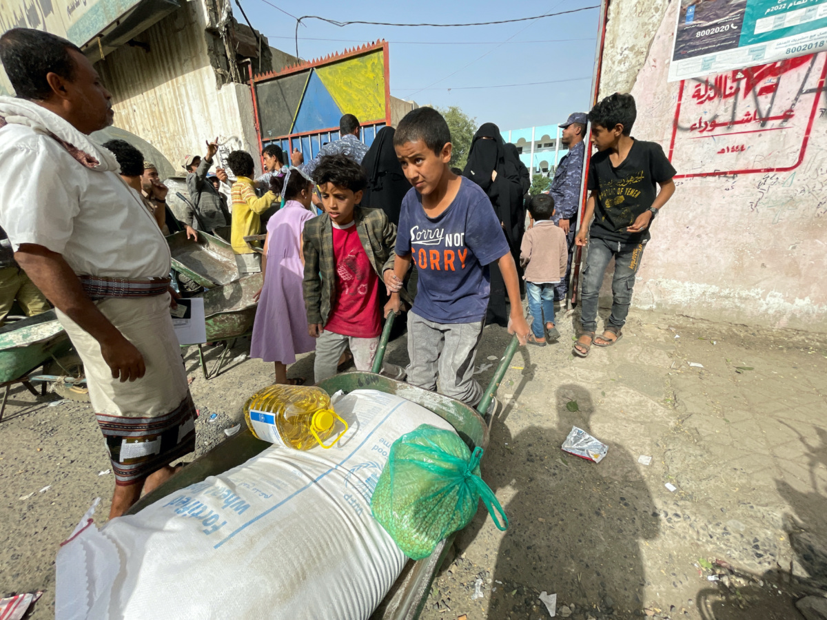 Yemen Sanaa boy carting food