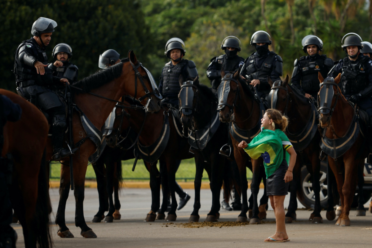 Brazil Brasilia security forces and a protestor