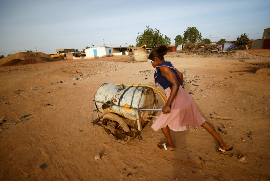 Burkina Faso Ouagadougou woman collects water