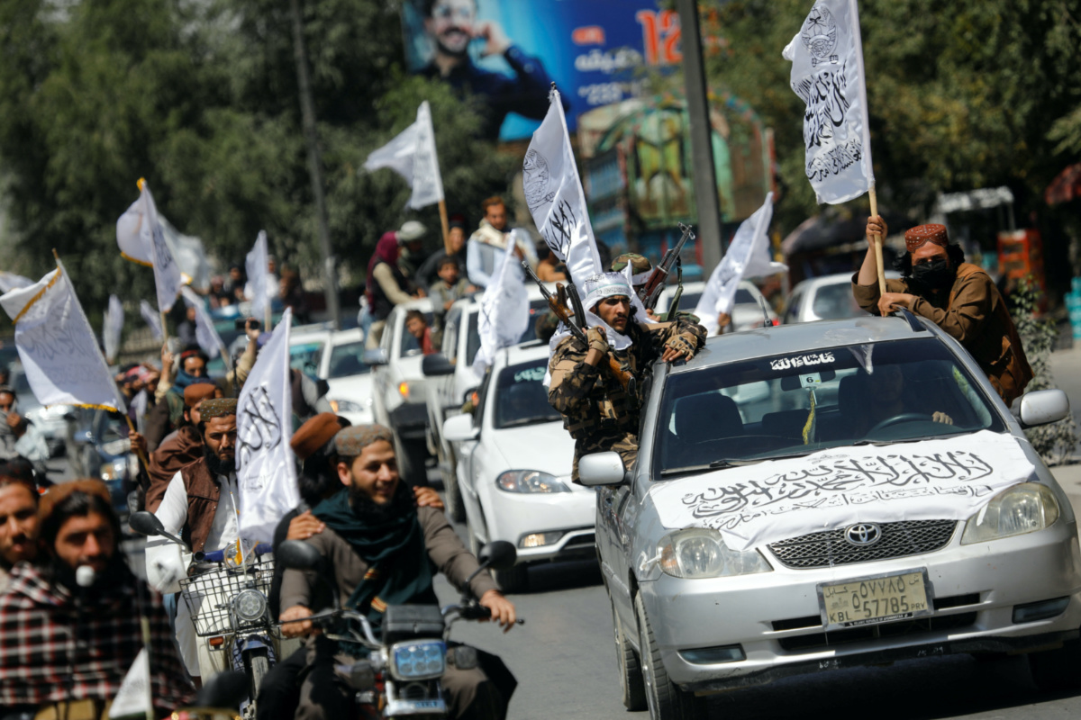 Taliban members drive in a convoy to celebrate the first anniversary of the withdrawal of U.S. troops from Afghanistan, along a street in Kabul, Afghanistan, August 31, 2022. REUTERS/Ali Khara/File Photo