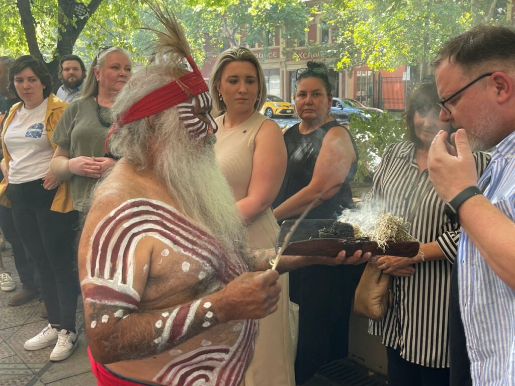 A Kaurna elder, Uncle Moogy, performs a traditional smoking ceremony with spectators, in Adelaide, Australia February 23, 2023. REUTERS/Jill Gralow