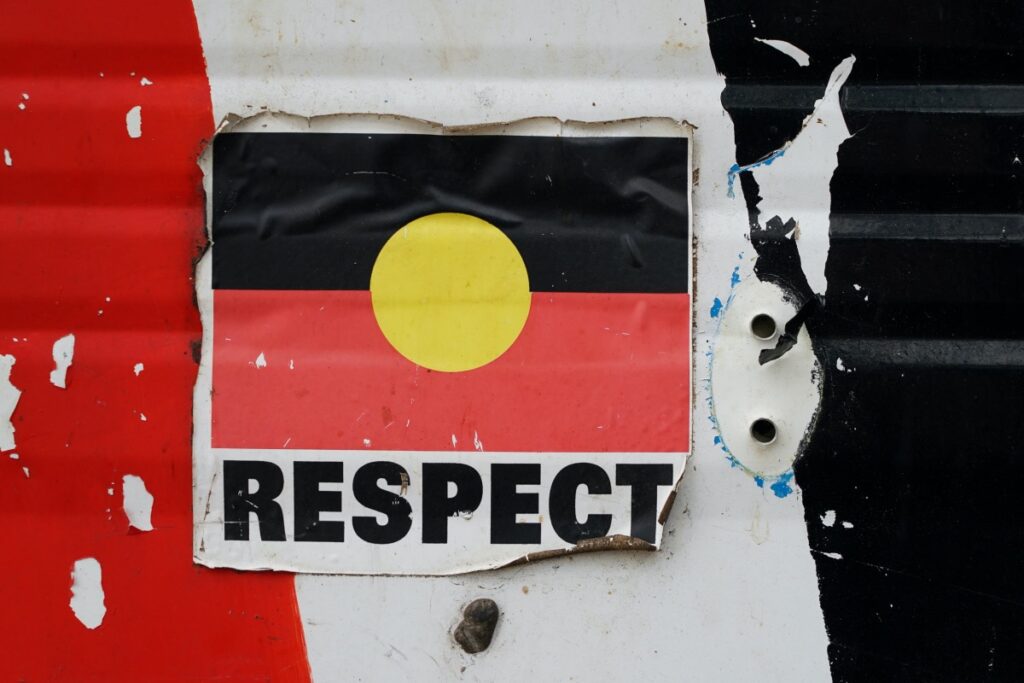 FILE PHOTO: A sticker of the Australian Aboriginal Flag along with the word "RESPECT" is pictured on a structure at the Aboriginal Tent Embassy, a site of protest since 1972, in Canberra, Australia, May 4, 2022. REUTERS/Loren Elliott