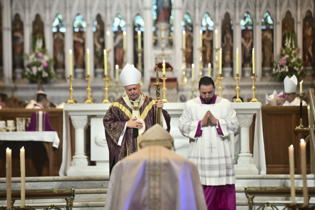 Archbishop Anthony Fisher, left, performs as principal celebrant of the requiem mass for Cardinal George Pell at St. Mary's Cathedral in Sydney, Thursday, Feb. 2, 2023. Pell, who died last month at age 81, spent more than a year in prison before his sex abuse convictions were overturned in 2020. (Giovanni Portelli/Pool via AP)