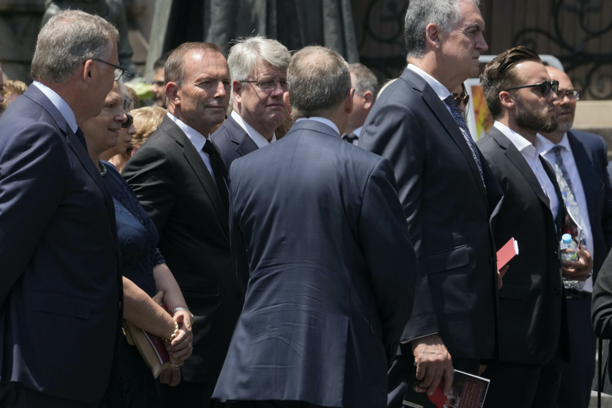 Former Australian Prime Minister Tony Abbott, third left, joins the procession following the funeral of Cardinal George Pell at St. Mary's Cathedral in Sydney, Thursday, Feb. 2, 2023. Pell, who died last month at age 81, spent more than a year in prison before his sex abuse convictions were overturned in 2020. (AP Photo/Rick Rycroft)