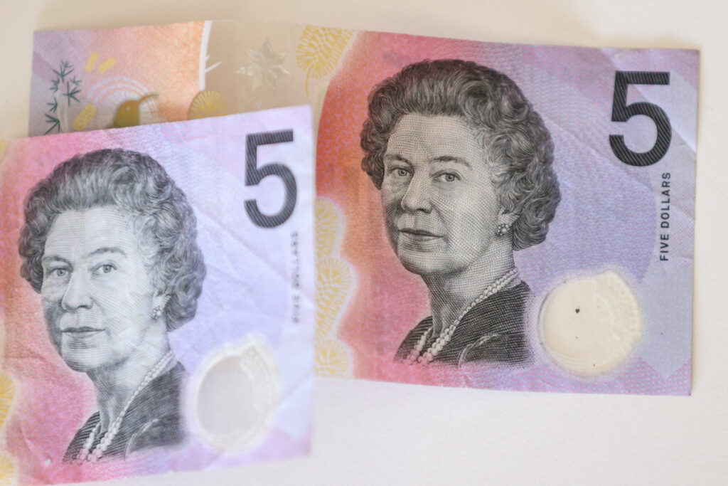 Australian $5 banknotes with a portrait of the late Queen Elizabeth II are seen in this picture illustration taken February 2, 2023. REUTERS/Loren Elliott/Illustration