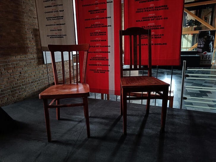 Two wooden chairs, one sent from Ukraine and one from Russia, symbolising casualties from Russia's war in Ukraine a century after "the war to end all wars" had ended, are shown on display at Belgium's World War One museum In Flanders Fields, in Ypres, Belgium March 3, 2022. In Flanders Fields Museum/Handout via REUTERS THIS IMAGE HAS BEEN SUPPLIED BY A THIRD PARTY. NO RESALES. NO ARCHIVES.