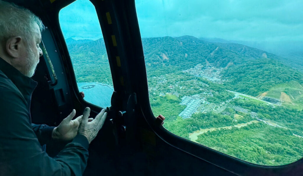 Brazil's President Luiz Inacio Lula da Silva flies in a helicopter over affected areas after torrential rain caused flooding and landslides in Sao Sebastiao, state of Sao Paulo, Brazil February 20, 2023.