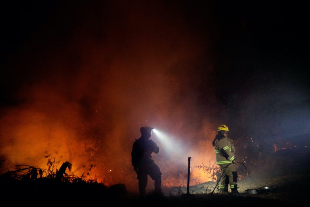 Firefighters work, as a wildfire burns parts of rural areas in Quillon, Chile, February 2, 2023 REUTERS/Juan Gonzalez