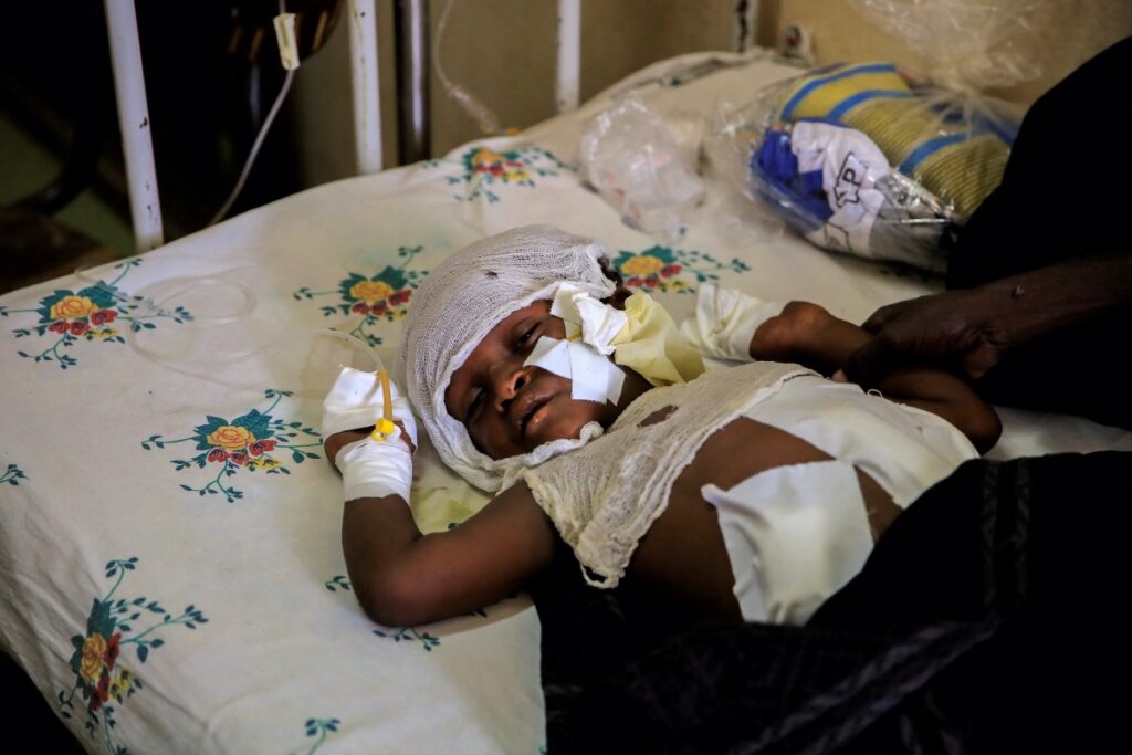 FILE PHOTO: Dawud Ali, 8, sleeps next to his uncle, Mohammed Ali, 40, after losing fingers from explosives that were left close to his house in the aftermath of fighting between the Ethiopian National Defence Force (ENDF) and the Tigray People's Liberation Front (TPLF) forces, at Dubti Referral Hospital, Dubti town, Afar region, Ethiopia, February 24, 2022. REUTERS/Tiksa Negeri