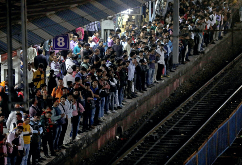 Commuters crowd on a platform as they wait to board suburban trains at a railway station in Mumbai, India, January 20, 2023.