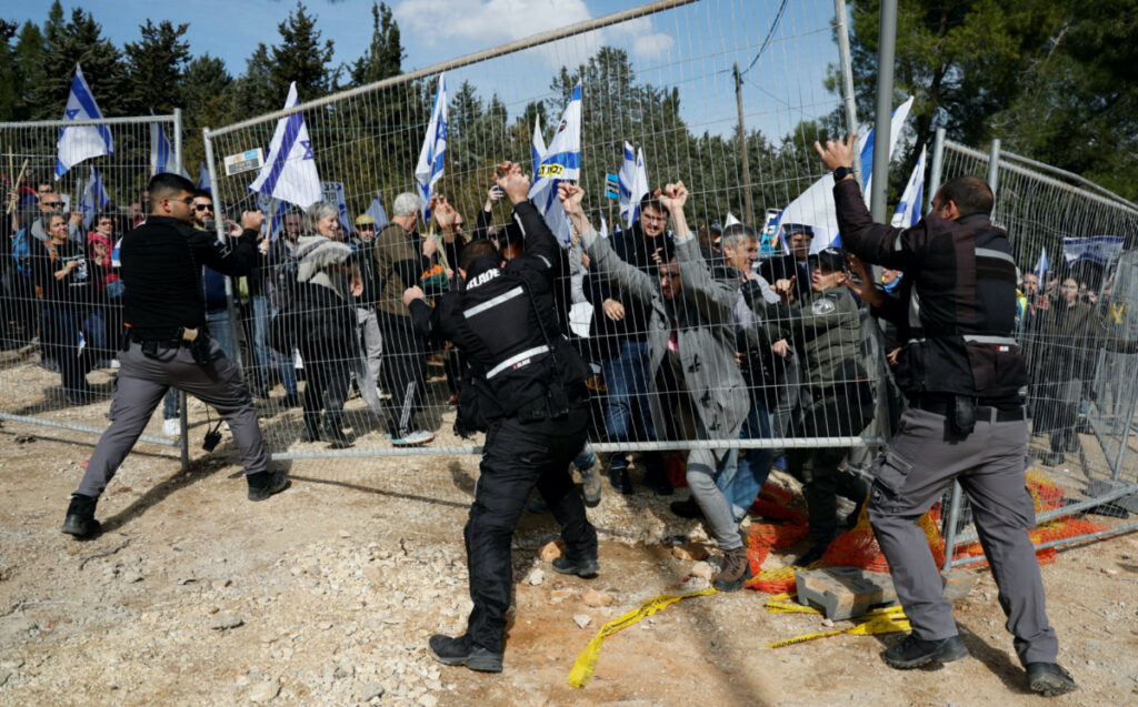 Israeli protestors clash with Israeli police officers as they demonstrate on the day Israel's constitution committee is set to start voting on changes that would give politicians more power on selecting judges while limiting Supreme Court's powers to strike down legislation, outside the Knesset, Israel's parliament in Jerusalem, February 13, 2023.