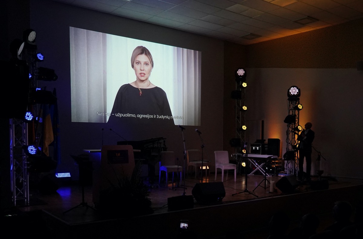 A TV screen shows Ukraine's first lady Olena Zelenska during an event marking the one year anniversary of Russia's invasion of Ukraine, at a Ukrainian refugee shelter in Vilnius, Lithuania February 23, 2023. REUTERS/Janis Laizans