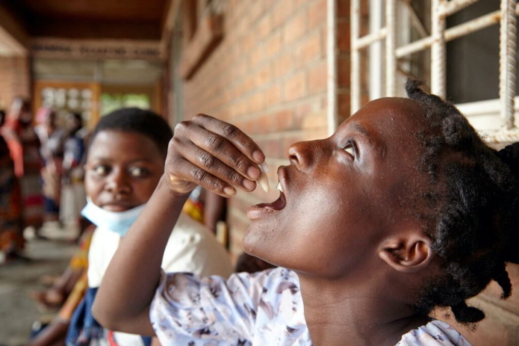 Eliza Tangwe, 18, takes a dose of oral cholera vaccine at a health centre in response to the latest cholera outbreak in Blantyre, Malawi, November 16, 2022.