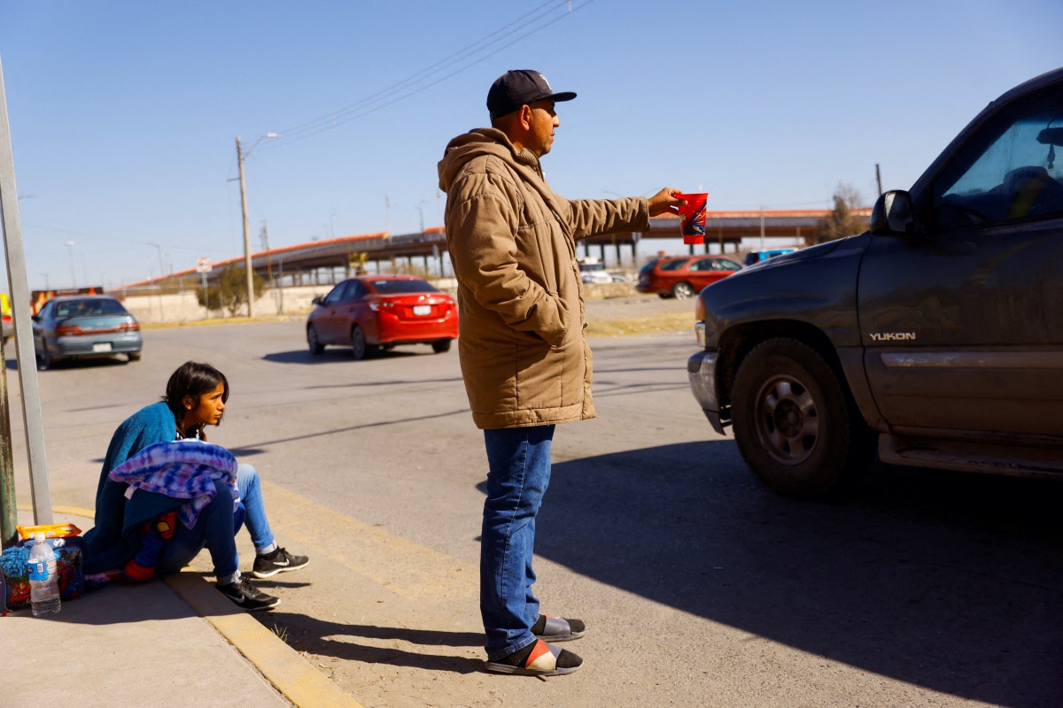 Cesar Galeano, a Venezuelan migrant trying to apply for asylum in the United States for him and his family with the US Customs and Border Protection CBP ONE application, asks for money on a street near the border between Mexico and United States, in Ciudad Juarez, Mexico February 2, 2023.