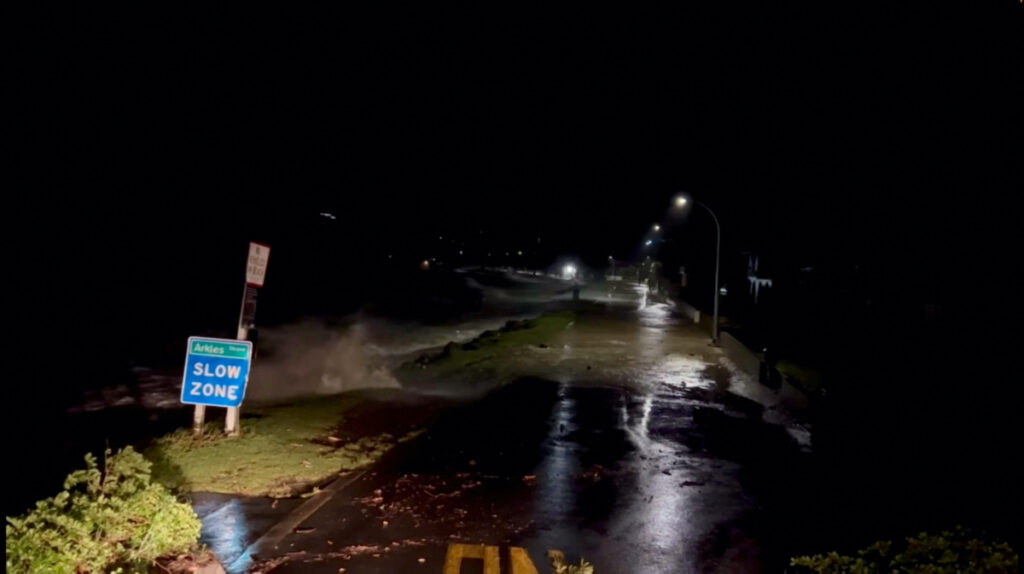 A view shows high tides rising due to Cyclone Gabrielle in Arkles Bay, Auckland, New Zealand February 13, 2023 in this screen grab obtained from a social media video. John Longson/Twitter @JohnLongson/via REUTERS