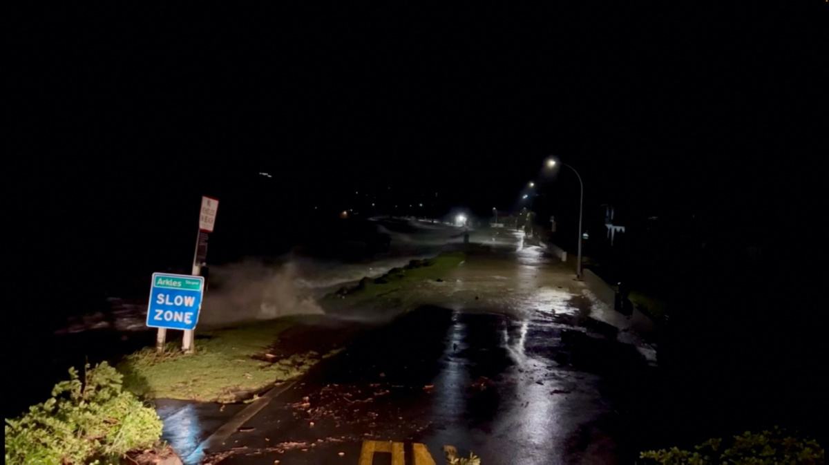 A view shows high tides rising due to Cyclone Gabrielle in Arkles Bay, Auckland, New Zealand February 13, 2023 in this screen grab obtained from a social media video. John Longson/Twitter @JohnLongson/via REUTERS