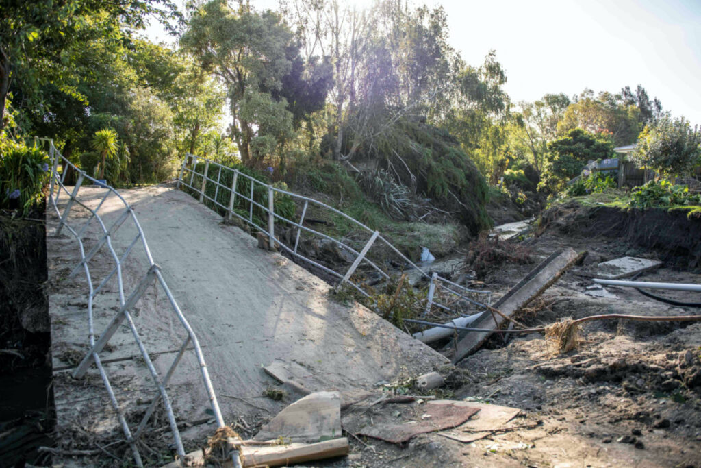 A general view of a damaged bridge after a small creek bursts its bank causing houses to flood in Havelock North, New Zealand. February 18, 2023. New Zealand Defence Force/Handout via REUTERS