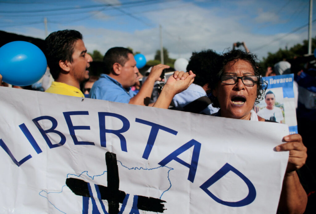 FILE PHOTO: A demonstrator takes part in a protest outside the "La Modelo" prison to demand the release of political prisoners in Tipitapa, Nicaragua June 19, 2019. The signs reads "Freedom" REUTERS/Oswaldo Rivas